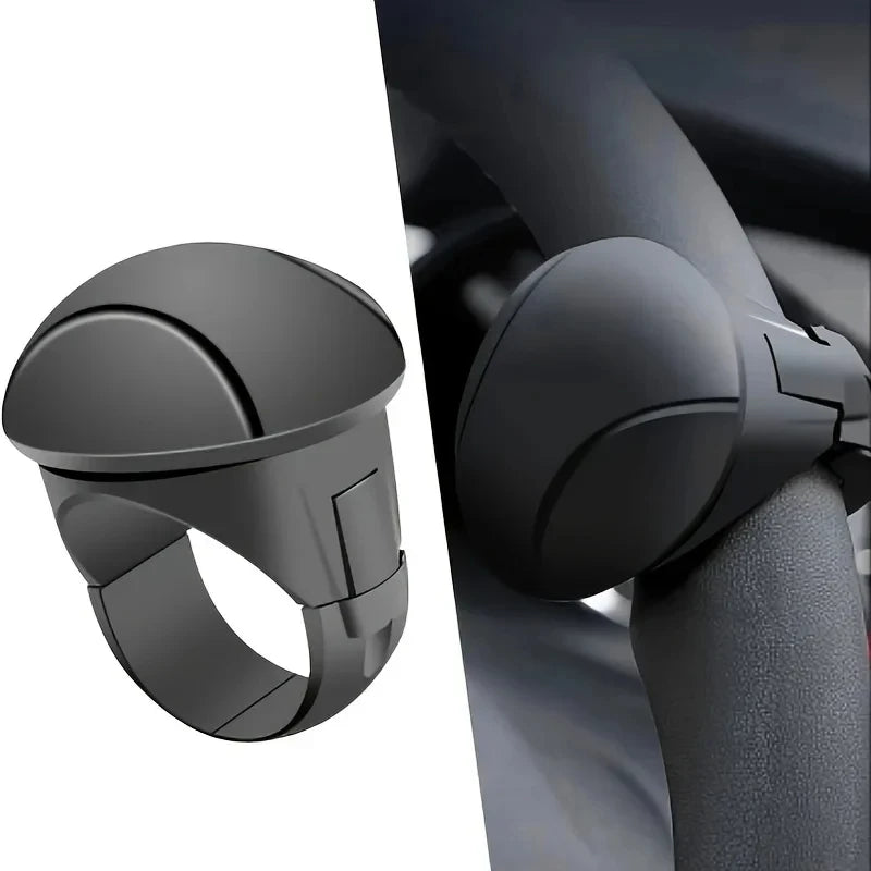 A close-up view of a black silicone steering wheel knob designed for one-hand control.