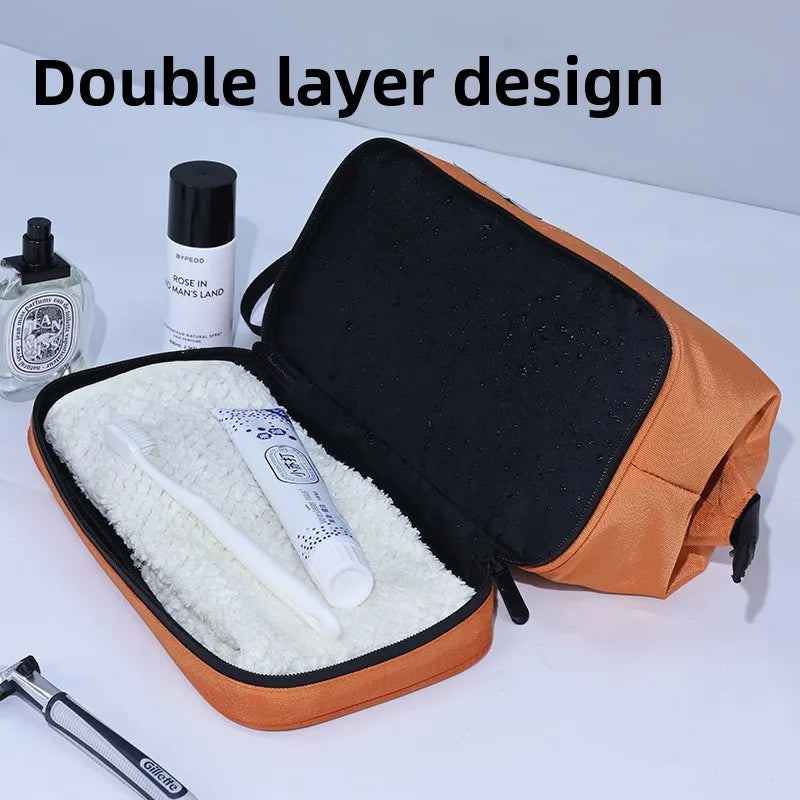 An open orange toiletry bag with a black lining, showing a white brush and a small bottle inside.