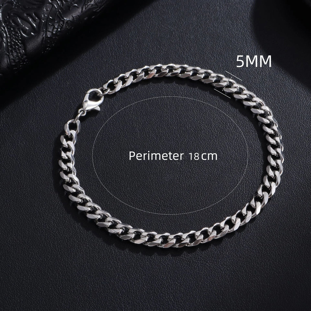 A silver stainless steel Cuban link bracelet shown on a dark background with measurements indicated.