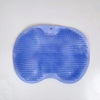 A light blue silicone scrubber pad with textured ridges used for showering or massage.