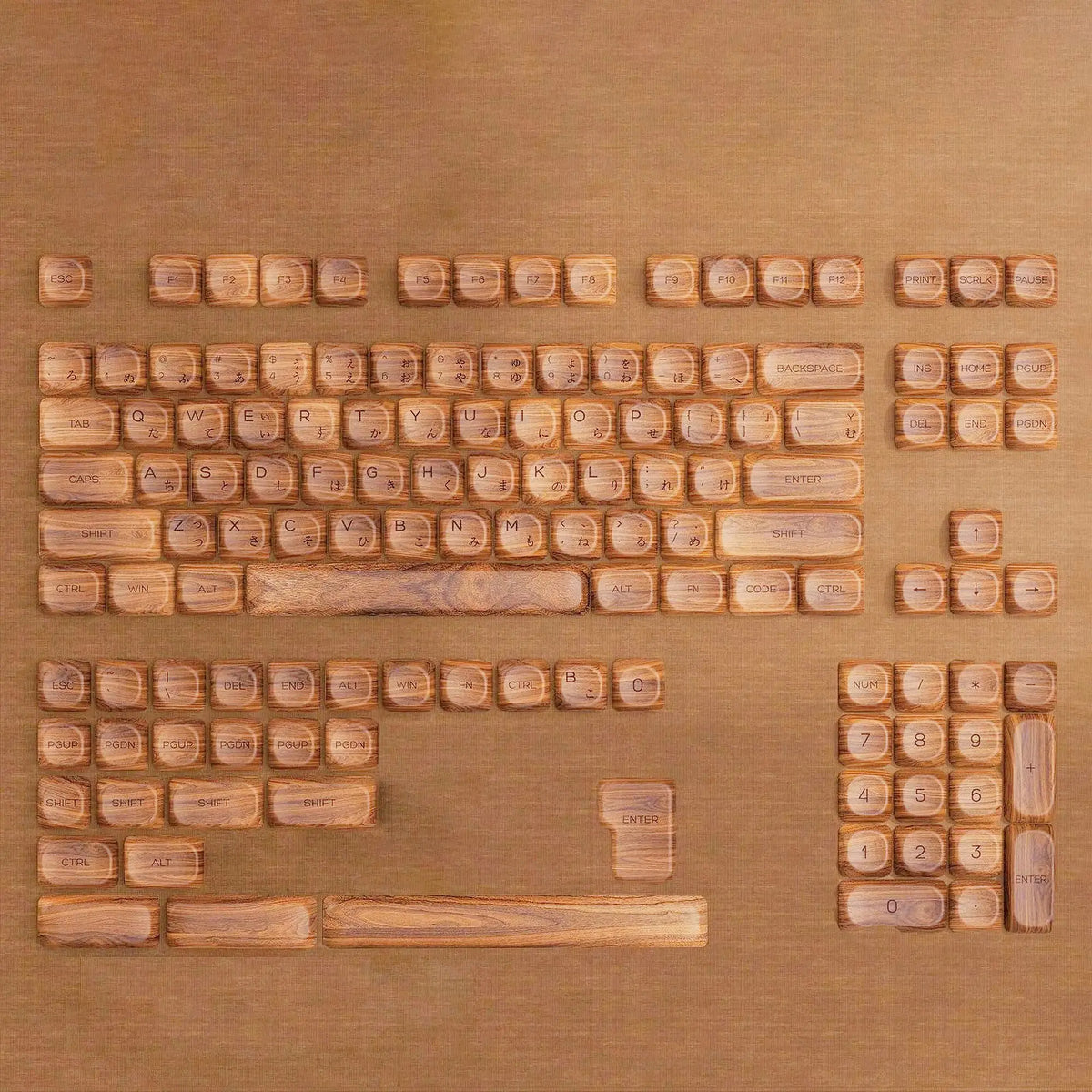 A close-up view of Ocean Blue MOA Profile PBT keycaps for mechanical keyboards laid out on a wooden surface.