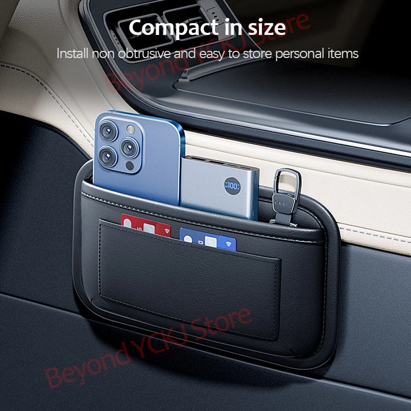 A black car seat side pocket organizer holding a smartphone and a card in a car interior.