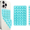 A white smartphone case and a blue silicone suction cup phone mount with multiple holes.