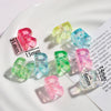 A collection of colorful acrylic alphabet beads in various shades and shapes displayed on a white surface.