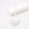 White heart-shaped PU leather keychain with a cotton peach charm