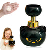 A black cat-shaped foam soap dispenser with gold accents is shown next to a hand and a child.