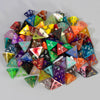 A pile of ten polyhedral dice in various colors and shapes for tabletop role-playing games