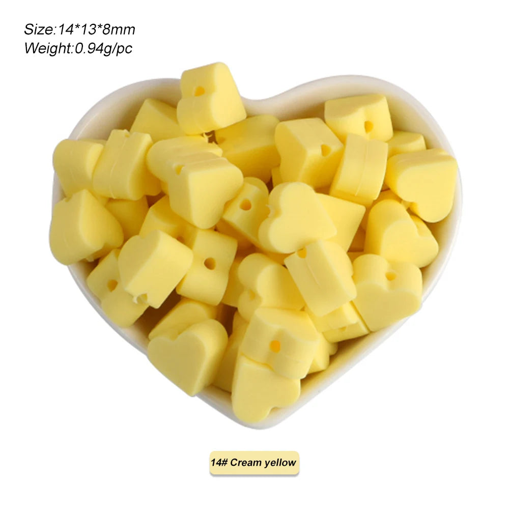 A pile of 14 cream yellow silicone crown star heart beads for DIY jewelry making