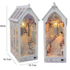 A white wooden book nook kit with an arched window display featuring a figure and floral decorations.
