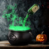 A dark cauldron emits a green fog mist with a floating potion effect against a dark background.