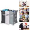 A foldable waterproof laundry basket with dark, light, and color sorting compartments shown next to laundry items.