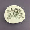 A white silicone mold shaped like a blooming rose flower for baking and crafting.