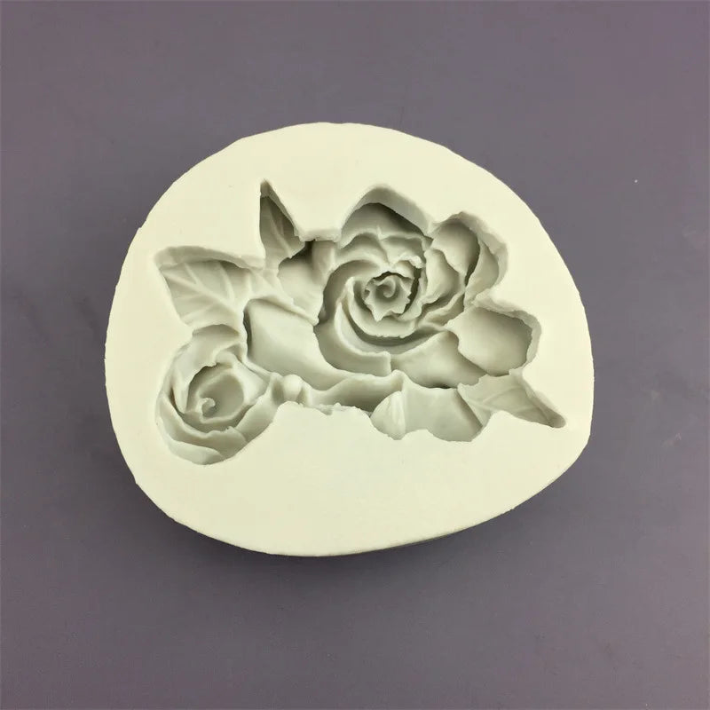 A white silicone mold shaped like a blooming rose flower for baking and crafting.