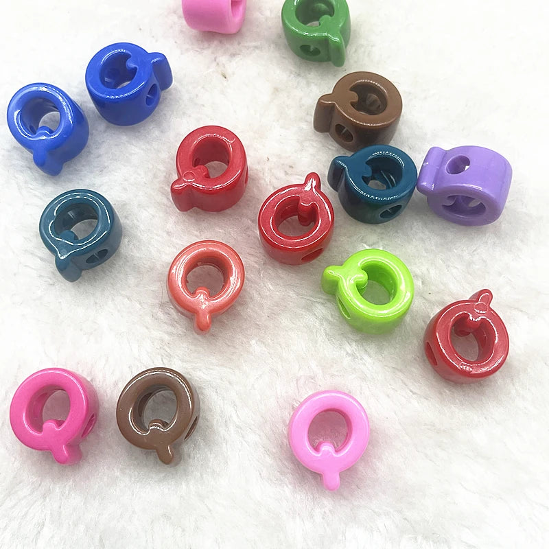 A collection of ten mixed colored letter beads in various shapes and sizes for DIY jewelry making