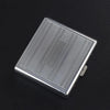 A silver stainless steel cigarette case with an embossed linear pattern shown from above.