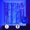 Blue LED curtain string lights with remote illuminating a window in a room