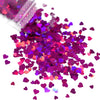 A pile of shiny holographic pink and purple star sequins for resin crafts.