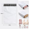 White self-sealing mailing bags with black tape and pink tissue paper inside