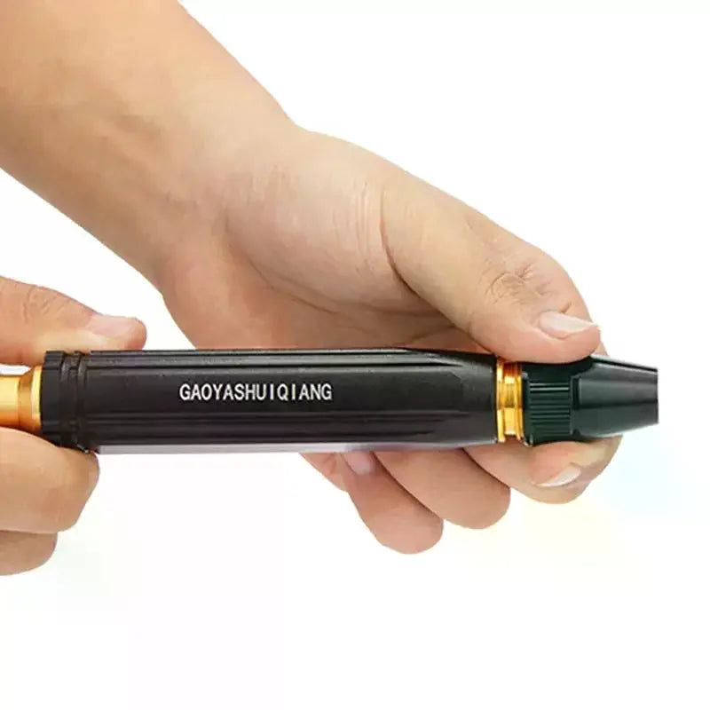 A hand holds a black and gold adjustable high-pressure water spray nozzle for car washing and garden watering.