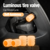 Close-up of a luminous self-illuminating tire valve cap and several orange glow-in-the-dark valve caps.