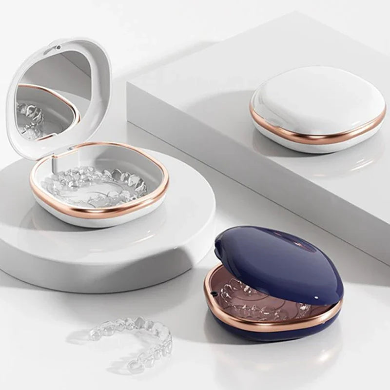 A set of compact orthodontic retainer cases featuring built-in mirrors and storage compartments in white and rose gold tones.