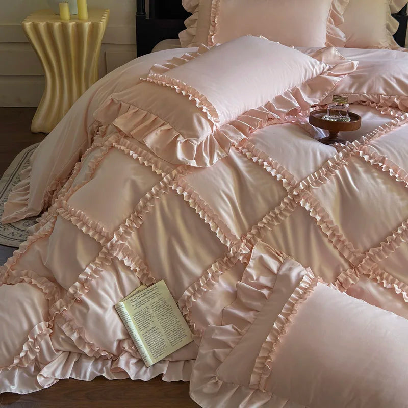 A pink ruffled duvet cover set with matching pillowcases and a decorative gold bedside table.