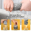 Hands are washing a gray microfiber cleaning cloth under running water, demonstrating soft long fibers and strong water absor