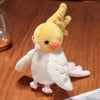 A yellow plush parrot hand puppet toy with pink beak and white feathers displayed on a clear stand.