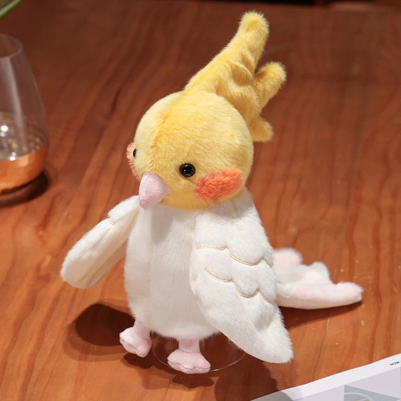 A yellow plush parrot hand puppet toy with pink beak and white feathers displayed on a clear stand.