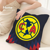A dark blue pillow featuring a yellow circular logo with the letters CA inside.