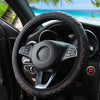 A black steering wheel with a red stitched leather cover is shown inside a car, viewed from the driver's perspective.