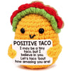 A handmade crochet taco plush with a colorful crocheted crown and a smiling face.