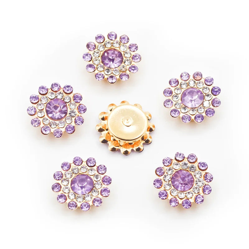 A collection of pink and purple sew-on flower rhinestones in various sizes and colors.