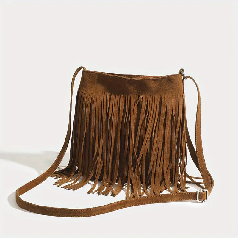 A brown bohemian fringe shoulder bag with long leather straps.