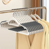 A rack of white plastic hangers with rotating hooks is displayed on a wooden hanger.