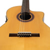 A close-up view of a yellow classical guitar showing the soundhole and bridge.
