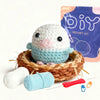 A beginner crochet kit featuring a cute white animal project, yarn balls, and a purple packaging bag.
