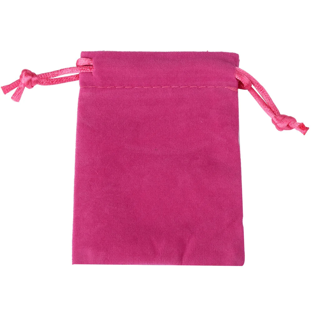 A magenta velvet drawstring jewelry pouch with pink ties.