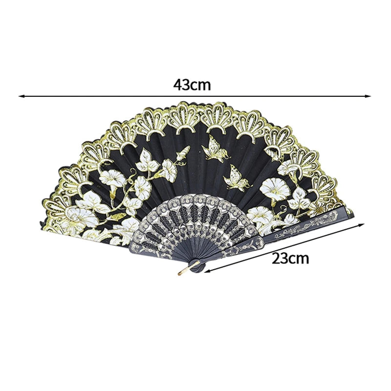 Black folding fan with white and gold lace trim and decorative patterns