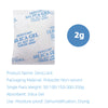 A white package of desiccant silica gel material with text instructions and a 2g weight indicator.