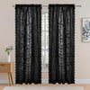 Black vintage floral lace sheer curtains in two panels hanging in a window frame.