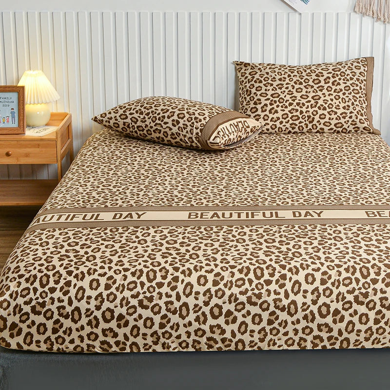 A leopard print fitted bed sheet with an all-around elastic band displayed on a bed.