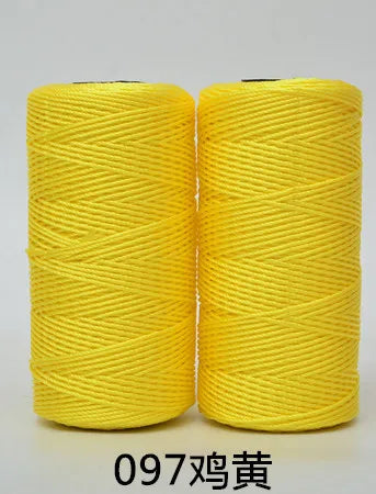 Two spools of bright yellow 3-ply polyester knitting yarn for crochet and hand crafts