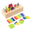 A wooden box filled with various colorful geometric shapes and sorting tools for toddlers.