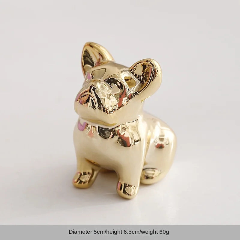 Gold-toned ceramic elephant and rabbit jewelry holder with a shiny finish