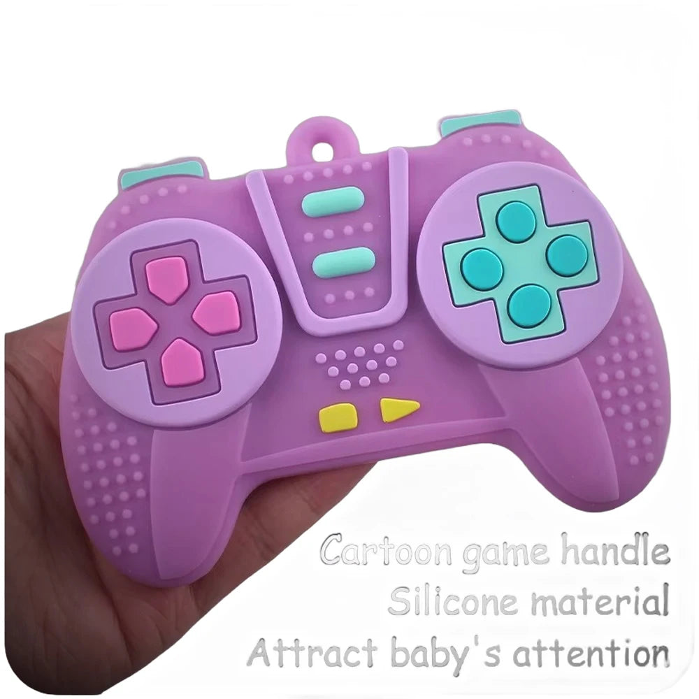 A purple silicone cartoon game controller held in a hand, designed to attract baby's attention.