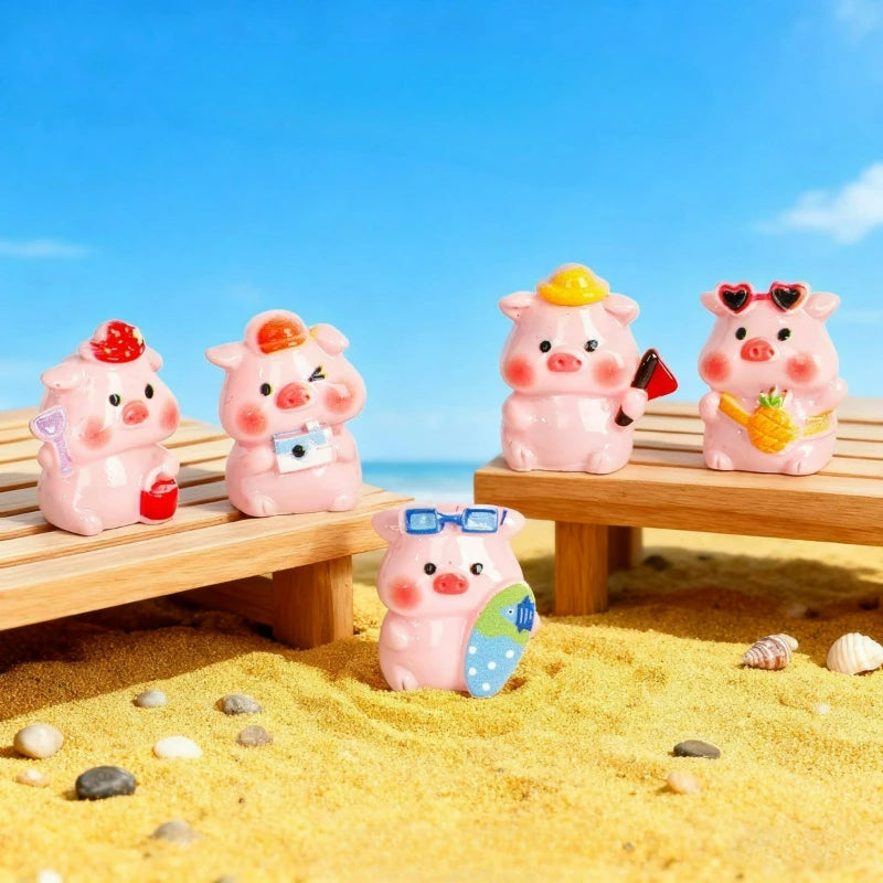 Pink resin pig figurines with yellow accents sitting on a wooden bench in a sandy outdoor setting