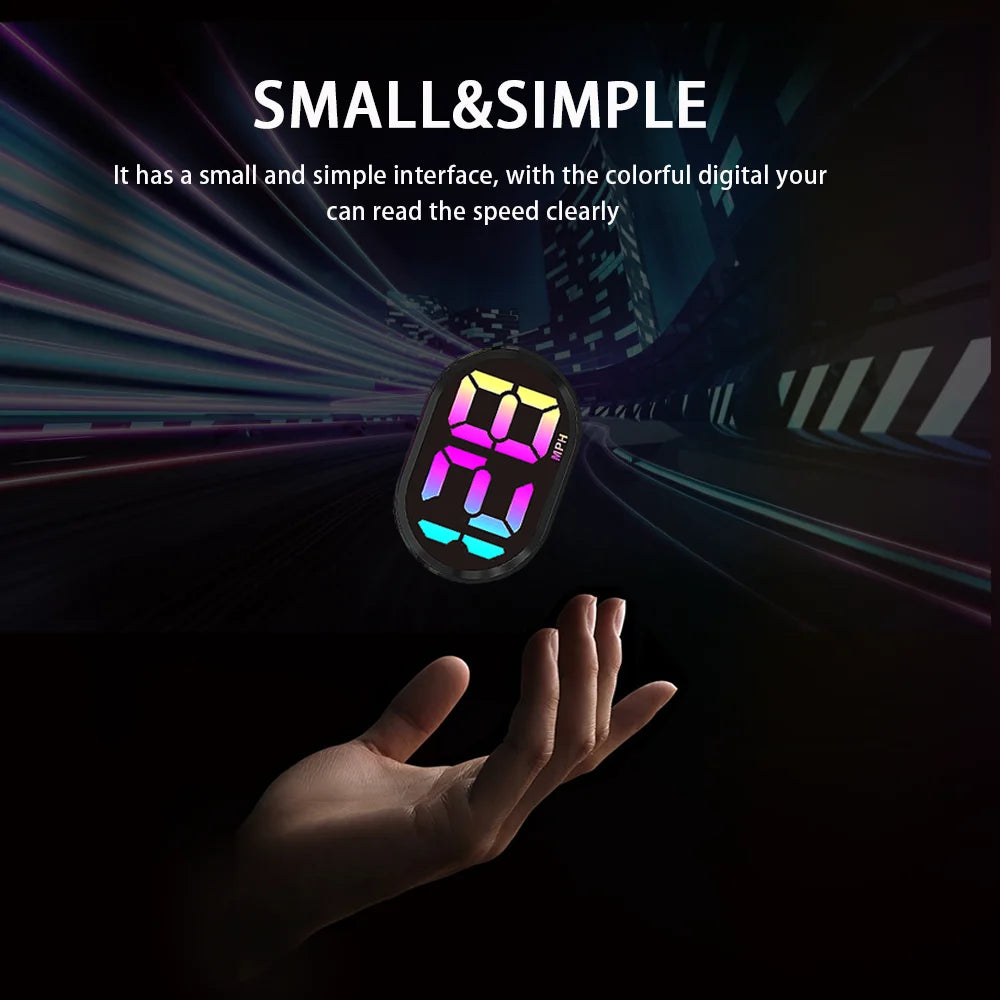 A hand is holding a small, glowing digital display showing speed, set against a dark background.