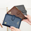 A collection of pink, green, and brown airplane pattern RFID-blocking passport wallets and card slots.