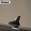 A close-up view of a sleek black shark fin roof antenna for VW and Audi models.